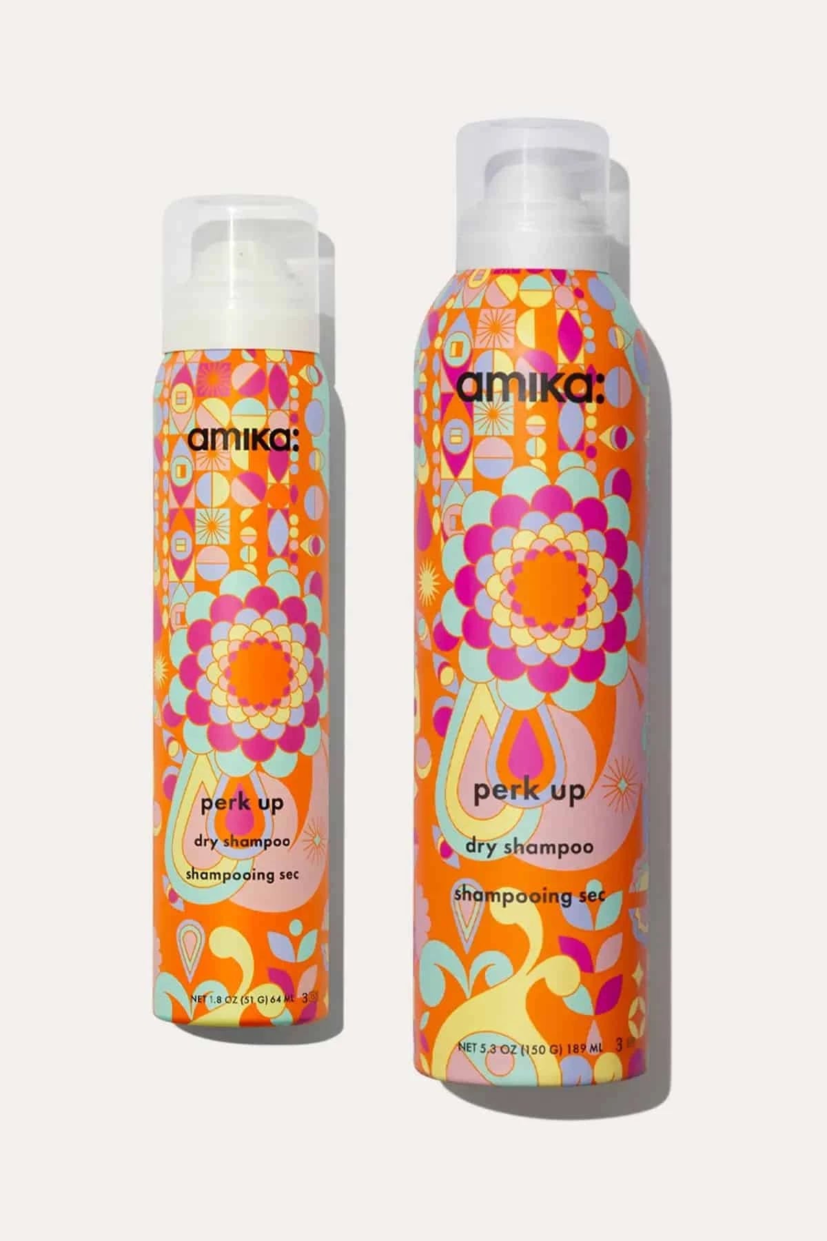 Two bottles of Amika Perk Up Dry Shampoo, offering instant freshness and volume without residue.
