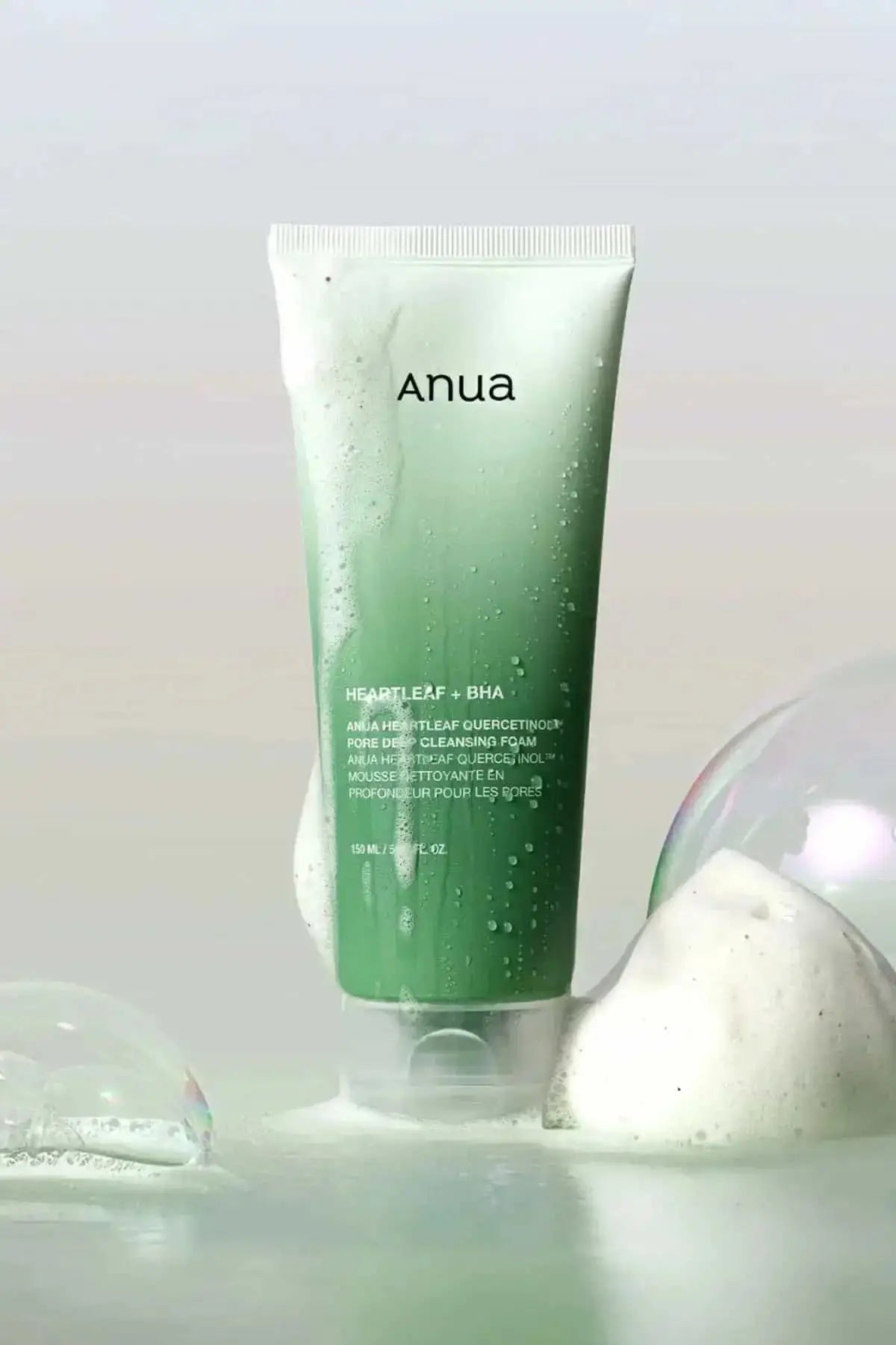 Artistic shot of Anua cleansing foam with dense bubbles, highlighting its refreshing feel as a cleanser for oily skin.