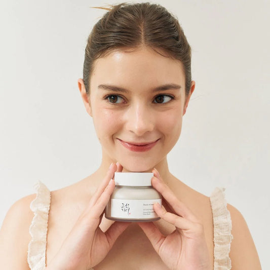 A model holding the Beauty of Joseon mask, recognized as the best face scrub for dry skin for a healthy glow.