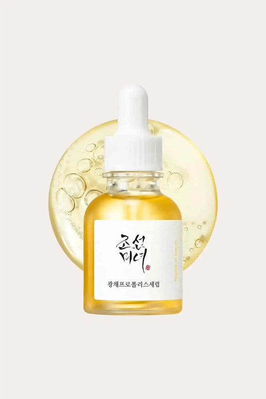 Stacked bottles of the Propolis + Niacinamide Glow Serum, recognized as a best serum for acne prone skin for its soothing properties.