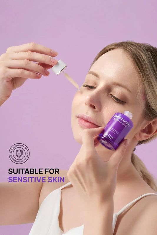 Bioheal BOH 3D Lifting Ampoule Suitable for Sensitive Skin - Best Korean Lifting Product, Anti Wrinkle Serum, Woman Applying Purple Bottle with Dropper on Purple Background, Dermatologist Tested