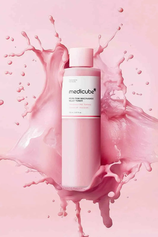 Medicube PDRN Pink Niacinamide Milky Toner bottle with a pink liquid splash, the first step for achieving GLASS SKIN.