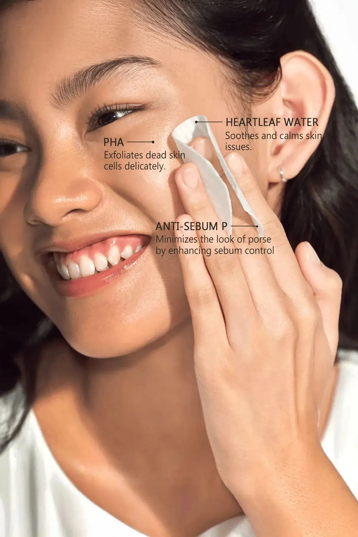 Model applying Anua TONER PADS featuring PHA for delicate exfoliation and Anti-Sebum P for enhanced sebum control.